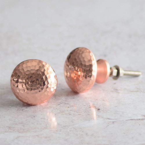 A Pair of Pushka Home Copper Hammered Rose Gold Cupboard Door Knob. Suits all doors up to 25mm thick. Great finishing touch for a shabby chic furniture project. Suitable for all kitchen cabinet doors. Perfect for up cycling your interior décor. These trendy designer door knobs will add style and glamour to any furniture!