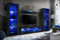 Komodee Wohnwand Wohnzimmerset Tivoli Grande, Schwarz/Schwarz, Breite 250cm x Höhe 159cm x Tiefe 35cm, LED Blau, für Wohnzimmer, Schlafzimmer