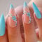 RUNRAYAY Blue Press on Nails Medium, Almond Acrylic Nails Press on Solid Fake Nails Teens with Flower Design, Nails Stick on for Daily Wear in 24Pcs