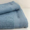 Novia - Set Asciugamani Enrico Coveri 1+1 con Balza Ricamata – Colore Azzurro, Taglia Unica