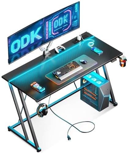 ODK Gaming Desk with LED Lights & Power Outlet, Gaming Table with Cup Holder and Headphone Hook, Double Z Frame Design Computer Desks, Carbon Fiber Black PC Desk 120 cm