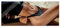Pixxprint Glasbild Panorama, Wandbild aus Echtglas, Frau in schwarzem Bikini liegt am Strand, 100x40 cm, inkl. Aufhängung und Abstandshalter