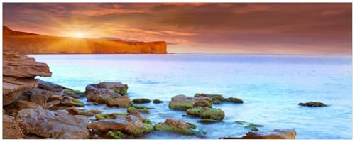Wallario Küchenrückwand selbstklebend 115 x 50 cm, Motiv: Sonnenaufgang am Meer mit Landzunge und Felsen im Wasser | Spritzschutz abwischbar & pflegeleicht