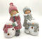 DARO DEKO Winterkinder Mädchen und Junge mit LED Schneemännern 27cm Dekofigur Weihnachtsdeko