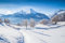 Acryl-Bild 80 x 50 cm: Schöne Winterlandschaft mit Bäumen und Berggipfeln in den Alpen an einem sonnigen Tag mit blauem Himmel und Wolken(121796093)