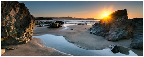 Wallario Küchenrückwand selbstklebend 115 x 50 cm, Motiv: Sonnenuntergang hinter einem Felsen am Strand | Spritzschutz abwischbar & pflegeleicht