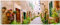 Wallario Glasbild Südländische Gasse mit Alten Häusern und grüner Oase - 50 x 125 cm Wandbilder Glas in Premium-Qualität: Brillante Farben, freischwebende Optik