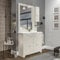 Mobile bagno a terra 105 cm bianco decape con 2 ante e 3 cassetti, lavabo in ceramica lucida, specchio 80x105 con cornice, pensile a lato DX e lampada, ROMANTICA