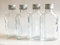 Taschi 12 Glass Bottles 100 ml Hip Flask With Screw Cap - Silver Refillable Liquor Schnapps Bottles for Vinegar Grain Oil - Height 12.7 cm