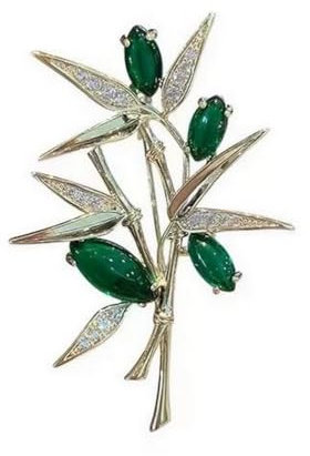 Broche bijou style fleur plante acier doré et cristal vert.