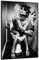 Wallario Wandbild - Kloparty - Sexy Frau auf Toilette mit Zigarette und Schnaps in Premiumqualität, Poster mit schwarzem Rahmen, Größe: 61 x 91,5 cm