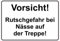 Schild Hinweisschild Hinweis Vorsicht Rutschgefahr bei Nässe auf der Treppe