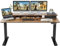 FEZIBO Height Adjustable Electric Standing Desk with Double Drawer, 150 * 60cm Stand Up Table with Storage Shelf, Sit Stand Desk with Splice Board, Black Frame/Rustic Brown Top