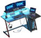 ODK Scrivania Gaming Angolare con Luci LED e Prese di Corrente, Postazione Gaming con Supporto per Monitor, Scrivania Computer con Ripiano di Stoccaggio Fibra di Carbonio Nera 120x70 cm