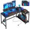Bestier 132.5 cm L-Shaped Workstation with Carbon Fibre Surface, 3 Power Outlets & 2 USB Ports, LED Strip Lights – Reversible Corner Unit with Shelves & Hooks for Home Office & Gaming