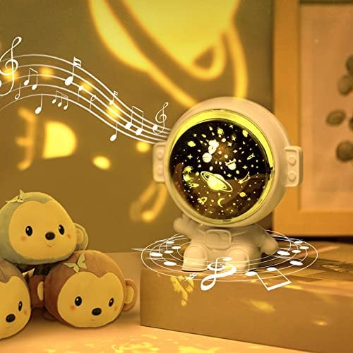 URAQT Luci di Proiezione dell'Astronauta, Rotazione a 360° di Proiettore Stelle Bambini, 8 Tipi di Musica Lampada di Proiezione Astronauta con Ricarica USB, Giocattolo e Regalo per Bambini e Neonati