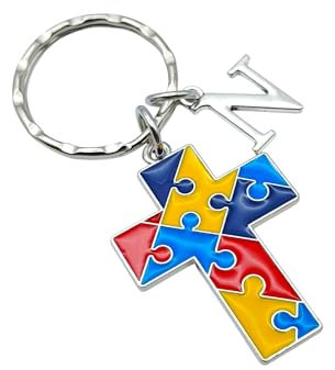 Autism awareness keyring. A silver tone keyring or bag charm with cross and initial charms. Multicoloured jigsaw pieces to represent Autism awareness