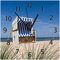 Wallario Design-Wanduhr Strandkorb aus Glas, Motiv-Uhr Größe 30 x 30 cm, Schwarze Zeiger