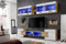 Komodee, Wohnwand Wohnzimmerset RTV Foggia, Front in Weiß Hochglanz/Karkasse in Wotan Matt, Breite 230cm x Höhe 195cm x Tiefe 35cm, Ohne LEDs, für Wohnzimmer, Schlafzimmer