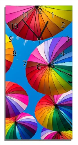 Wallario Design-Wanduhr, Acrylglasuhr Größe 30 x 60 cm, Schwarze Zeiger, Motiv Bunte Regenschirme vor blauem Himmel