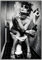 Wallario Wandbild - Kloparty - Sexy Frau auf Toilette mit Zigarette und Schnaps in Premiumqualität, Poster mit schwarzem Rahmen, Größe: 70 x 100 cm
