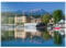 MyPuzzle Schlosshotel am See gegen Mittagskogel (2143m), Velden, Wörther See, Österreich - Premium 1000 Teile Puzzle - MyPuzzle Sonderkollektion von Puzzle Galaxy