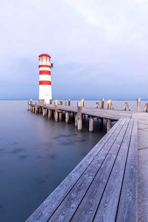 adrium Acryl-Bild 40 x 60 cm: Holzsteg mit Leuchtturm in Podersdorf am Neusiedler See in Österreich bei Sonnenaufgang. (173006882)