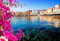 adrium Acryl-Bild 70 x 50 cm: Klares türkisfarbenes Wasser des Hafens von Chania an sonnigen Tagen mit Blumen, Kreta, Griechenland (120867074)