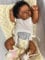 Anano Reborn Baby Vollsilikon Dunkelhäutige Puppe 50CM Lebensechte Babypuppen Realistische Babypuppe Newborn Baby Puppe Waschbar Geschenk Für Mädchen Sammler (Weißer Strampler mit Stirnband)