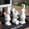 Super Idee 3er Set Stehende und Sitzende Osterhasen Figuren aus Keramik mit Blumen und Herzen Osterdeko zum Hinstellen 14 cm - Hasenfiguren als Ostergeschenk Hasen Ostern Deko