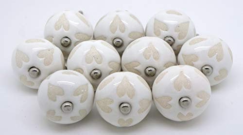 Pushka Home Set of 10 White with Cream Stencil Heart Ceramic Door Knobs Vintage Style. Antique looking 40mm ornament handles for your furniture doors. Sold as a pack of 10 as shown. Made of hardwearing porcelain. Suits doors up to 27mm thick.