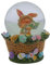 Dekohelden24 Schüttelkugel, Oster - Schneekugel, Schneekugel mit Osterhase, Osterhase im Korb, Osterkugel zum Schütteln, Hase mit bunten Blumen und Korb als Sockel, L/B/H 7 x 7 x 9 cm.